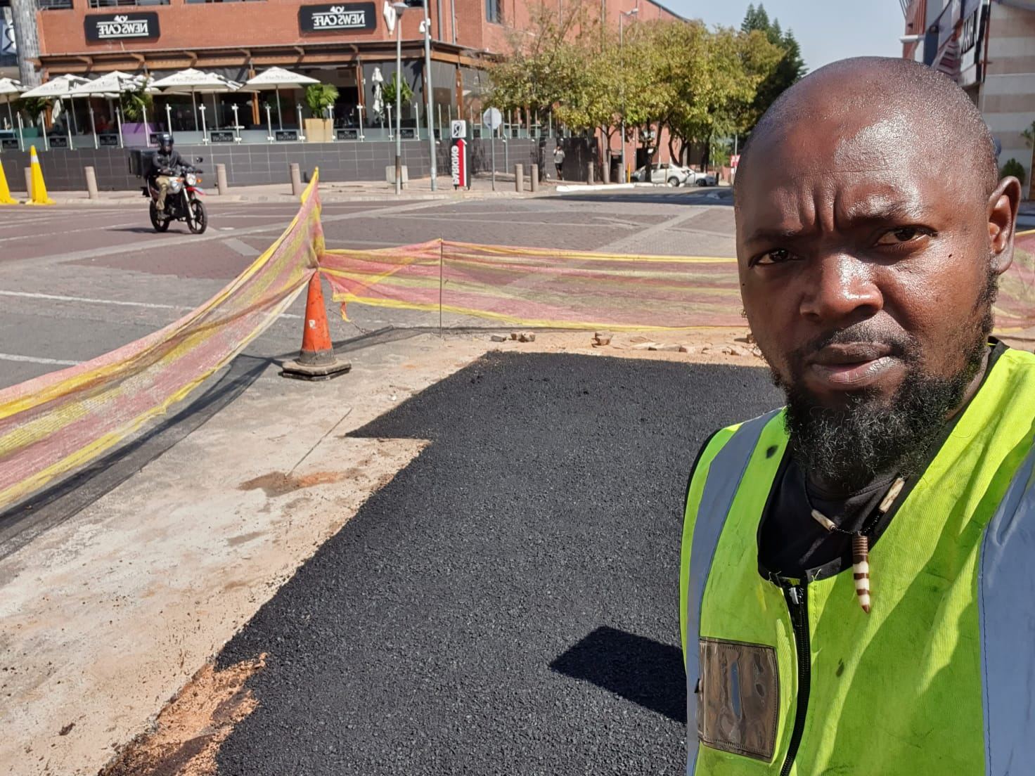 Tar surfacing crew working on a town street